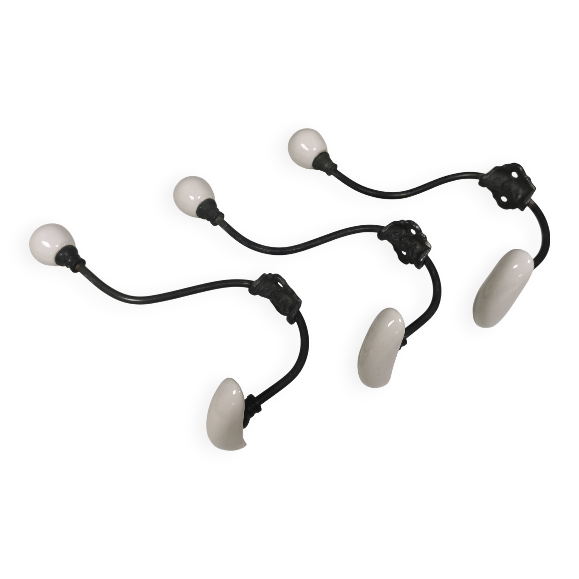 Coat hooks made of galvanized brass and raw white porcelain