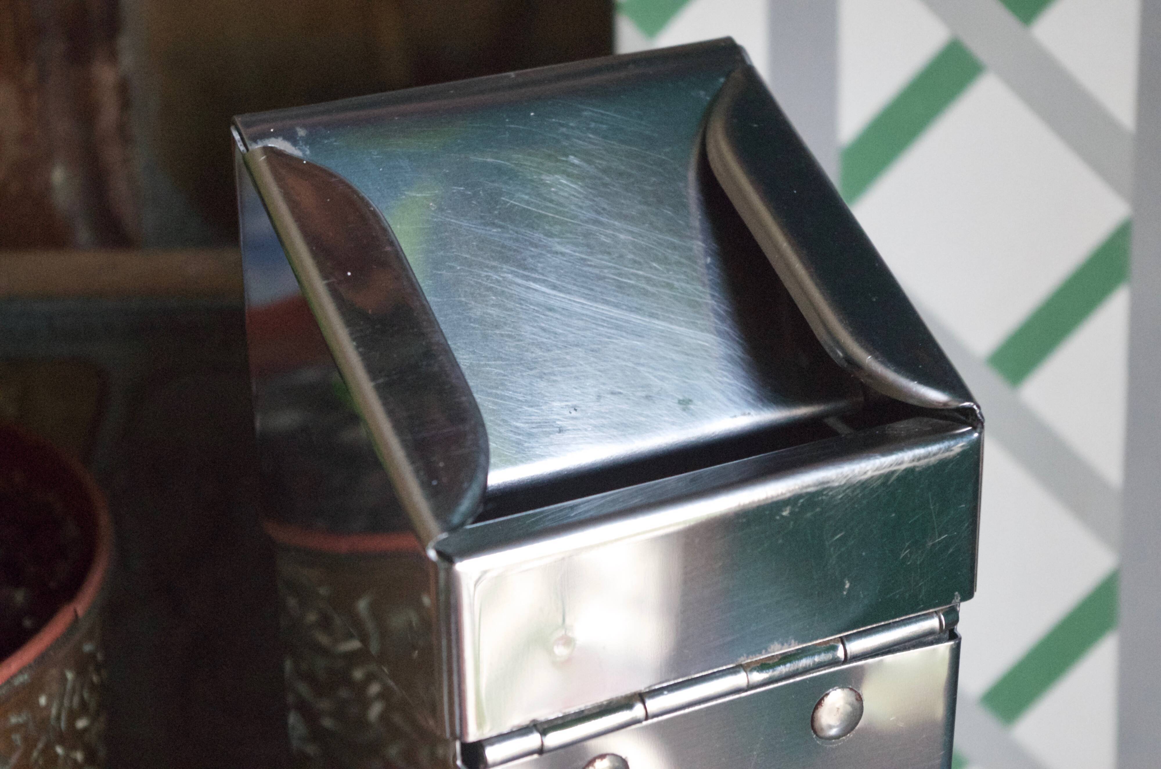 Vintage wall ashtray in shiny metal industrial style