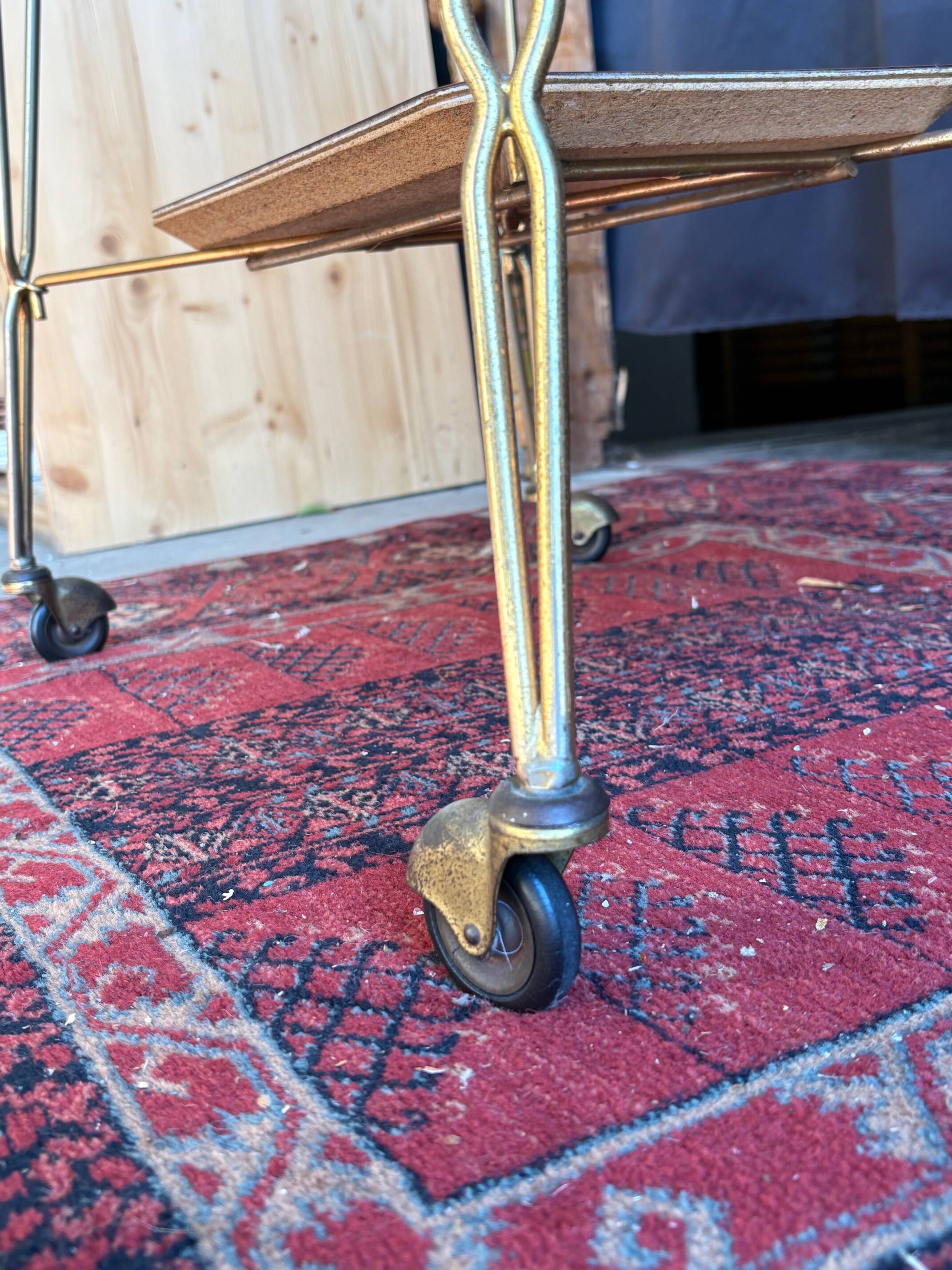 Vintage 1960s rolling dessert trolley in gold metal and formica.