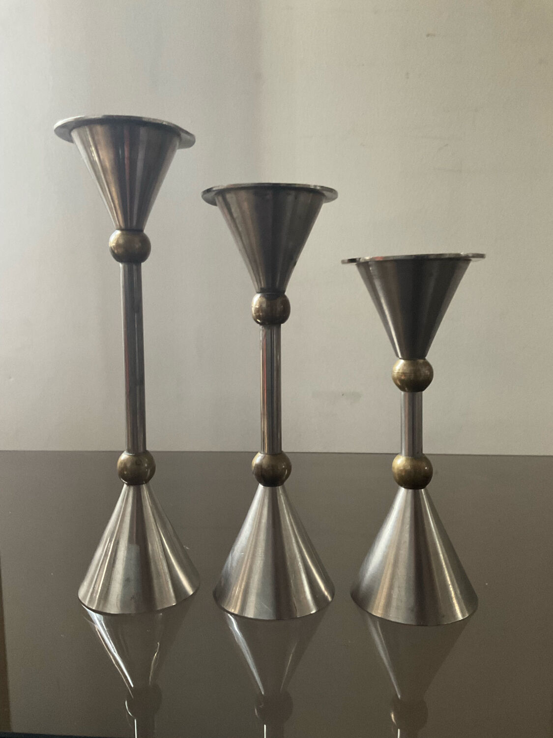 Trio of vintage metal and bronze candle holders