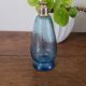 Small blue twisted glass bottle