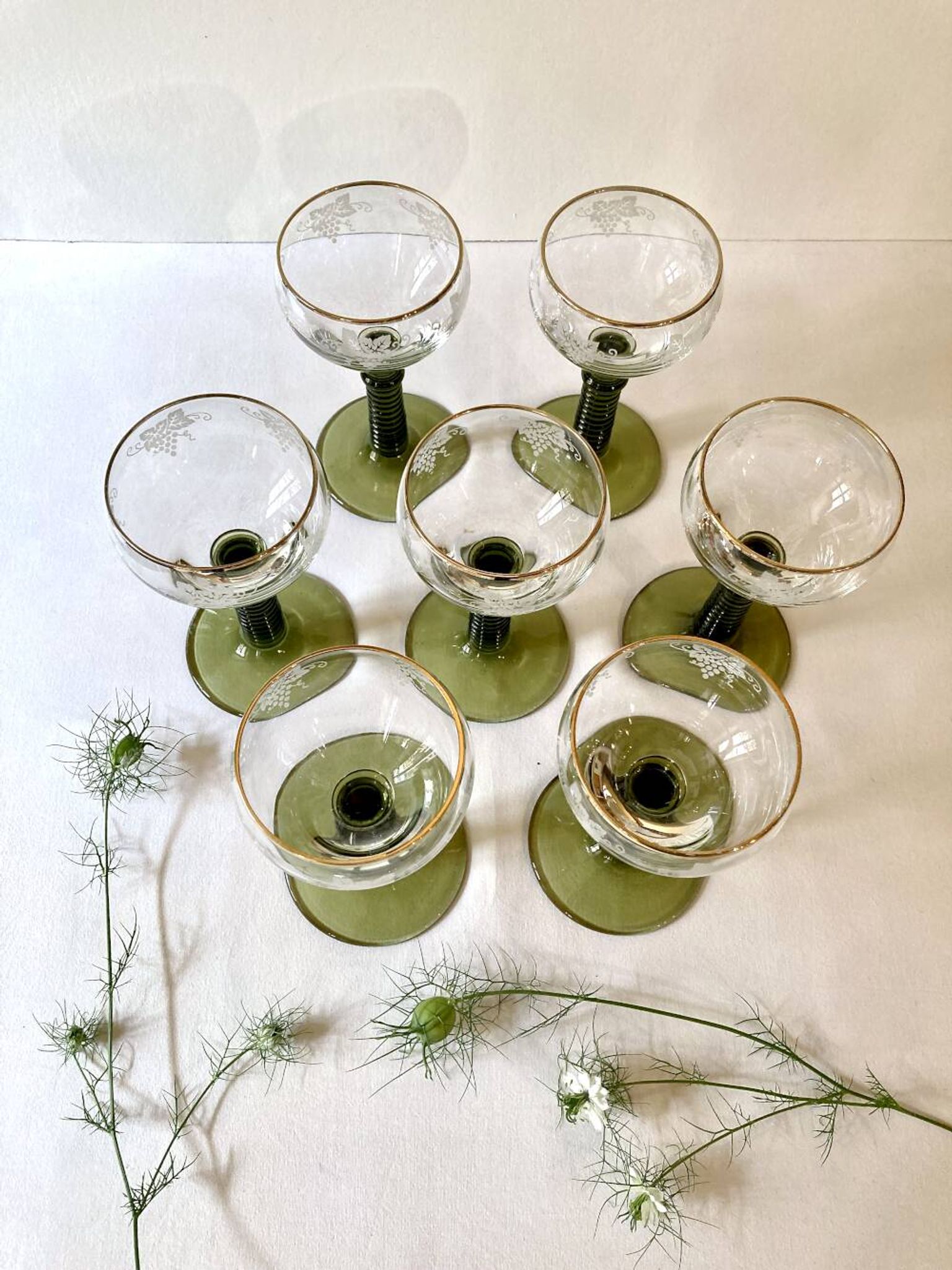 7 Alsace Roemer wine glasses, moss green stepped bases and gold trim.