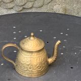 Small decorative teapot in vintage chiseled copper