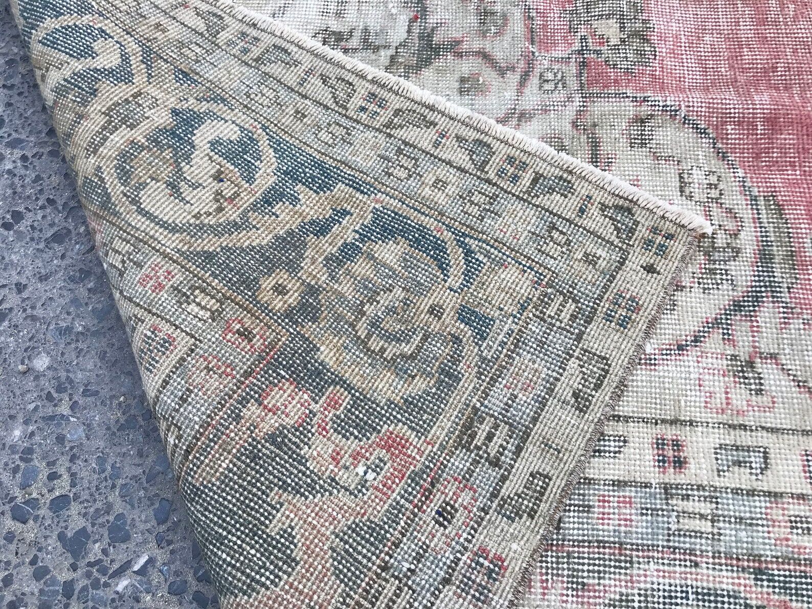 Pale pink rug with medallion