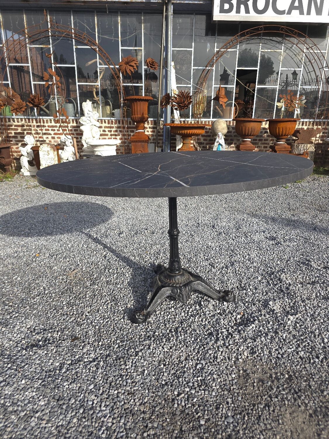 Bistro pedestal table with cast iron base and marble effect top