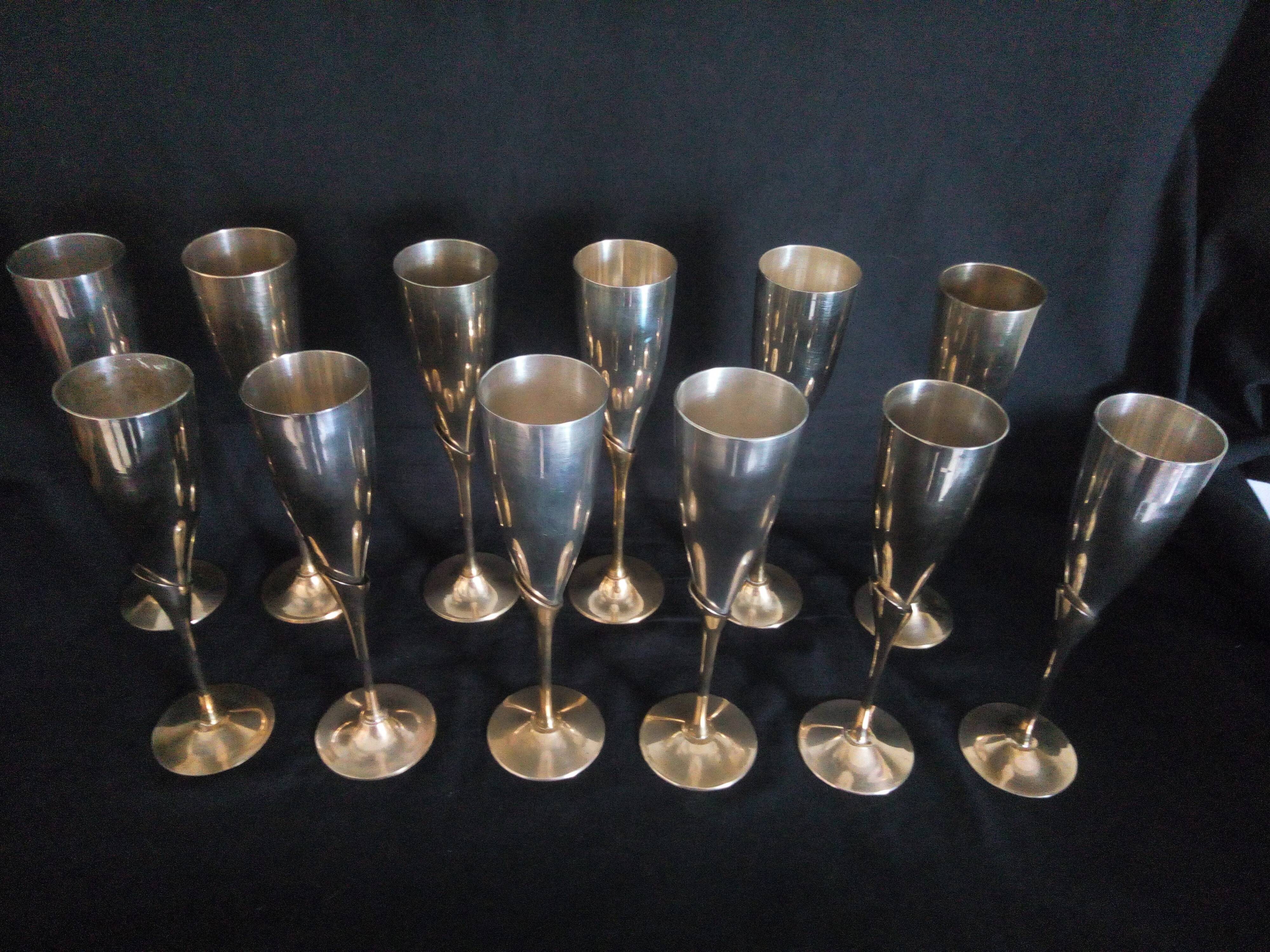 Lot of 12 silver metal flutes on brass stand