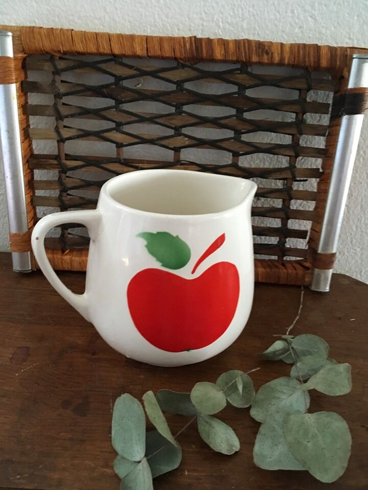 Vintage pitcher with apple decoration.