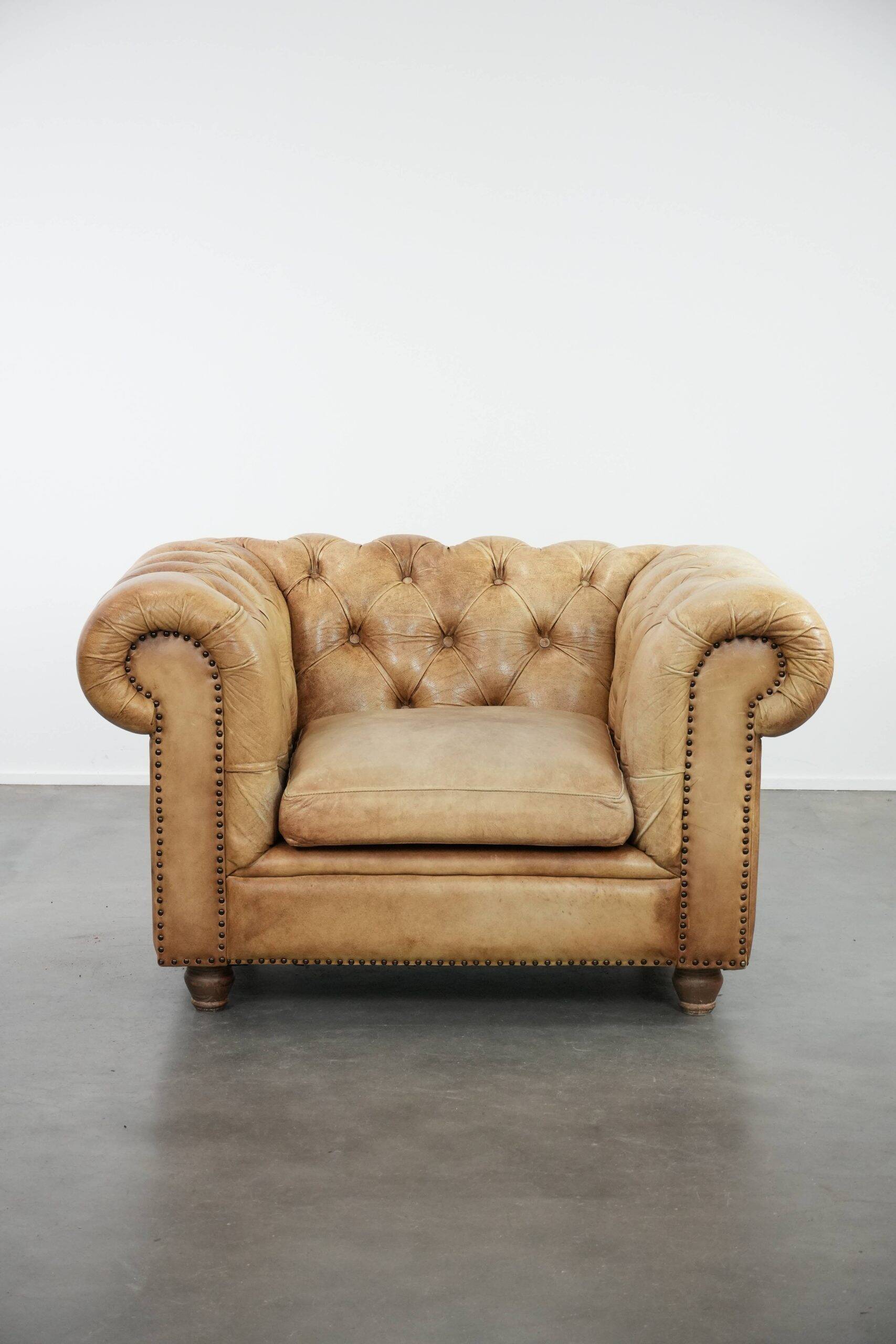 Chesterfield armchair made of cowhide leather in a light cognac colour