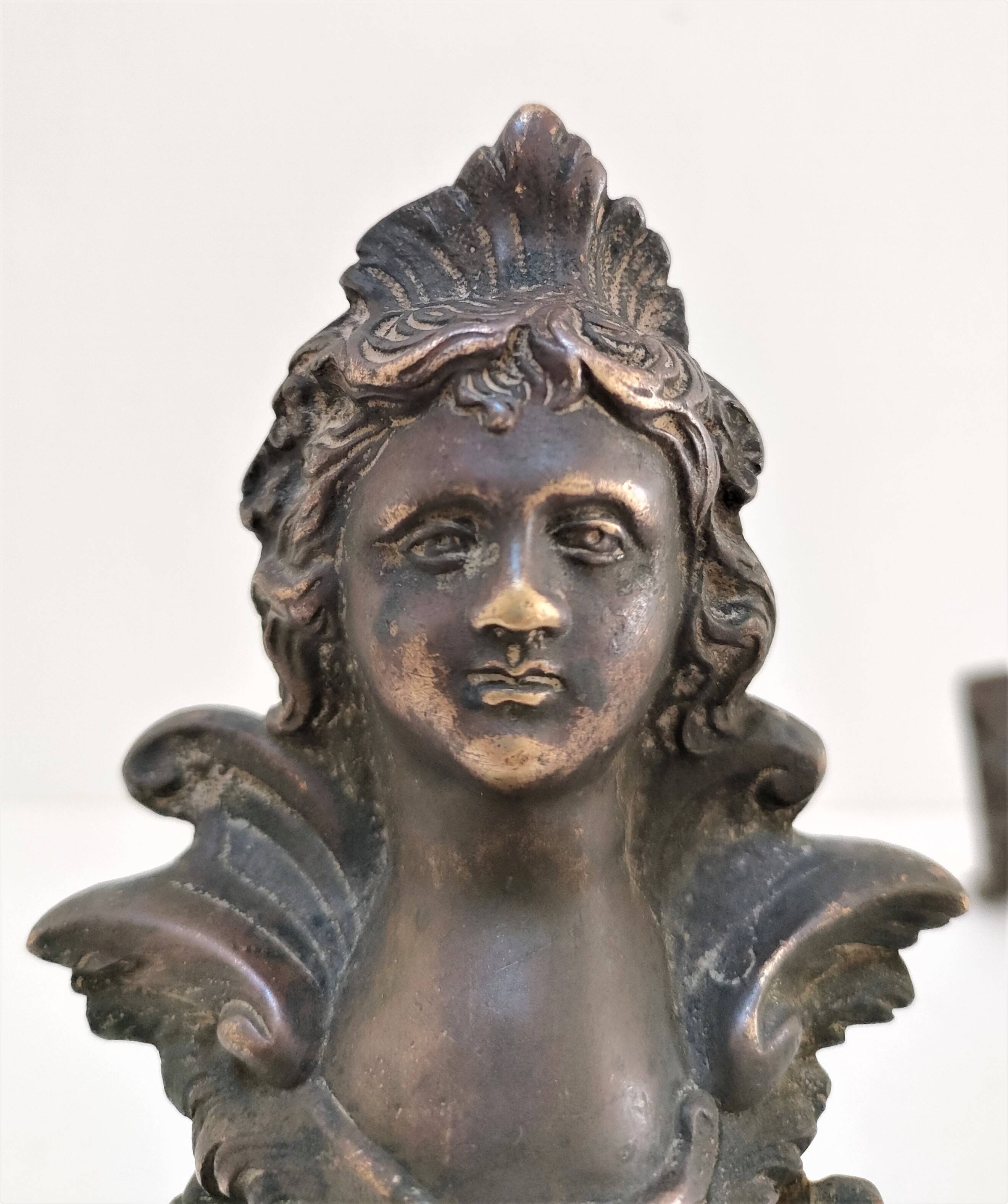 Pair of bronze andirons with black patina, 19th century, female caryatids