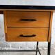 Black metal and wood mid-century industrial desk with laminated top and two drawers