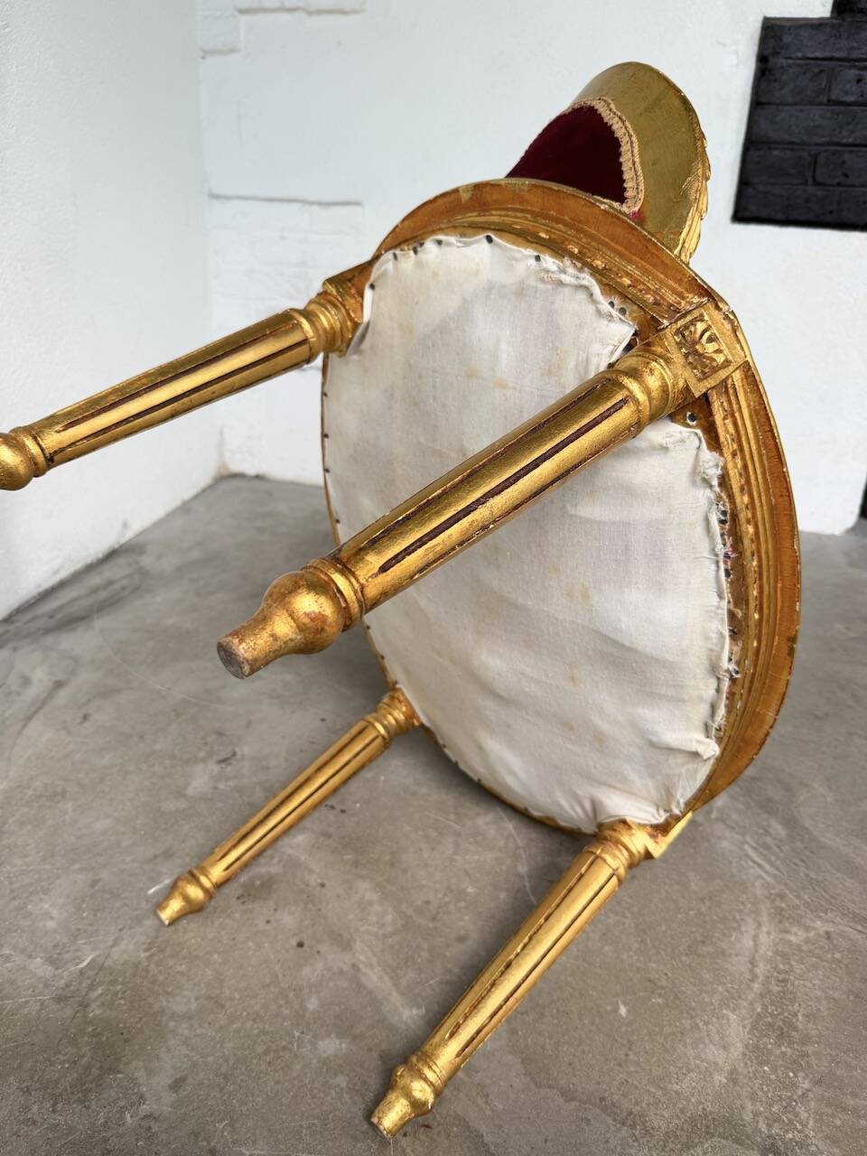 Louis XVI gilt wood and red velvet armchair