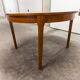 Scandinavian table in round teak with built-in extensions 1960