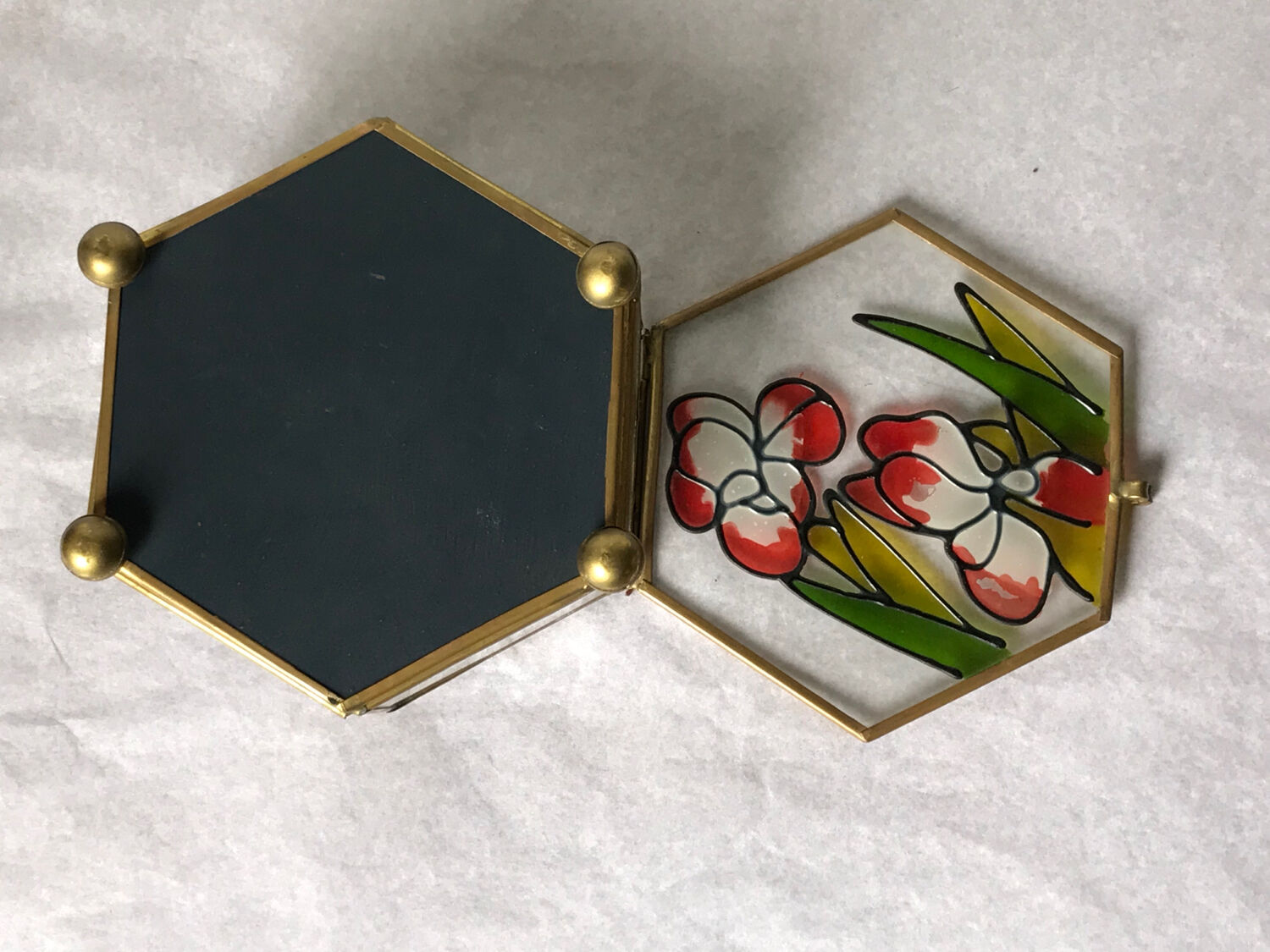 Glass box and hexagonal brass enamelled floral decoration