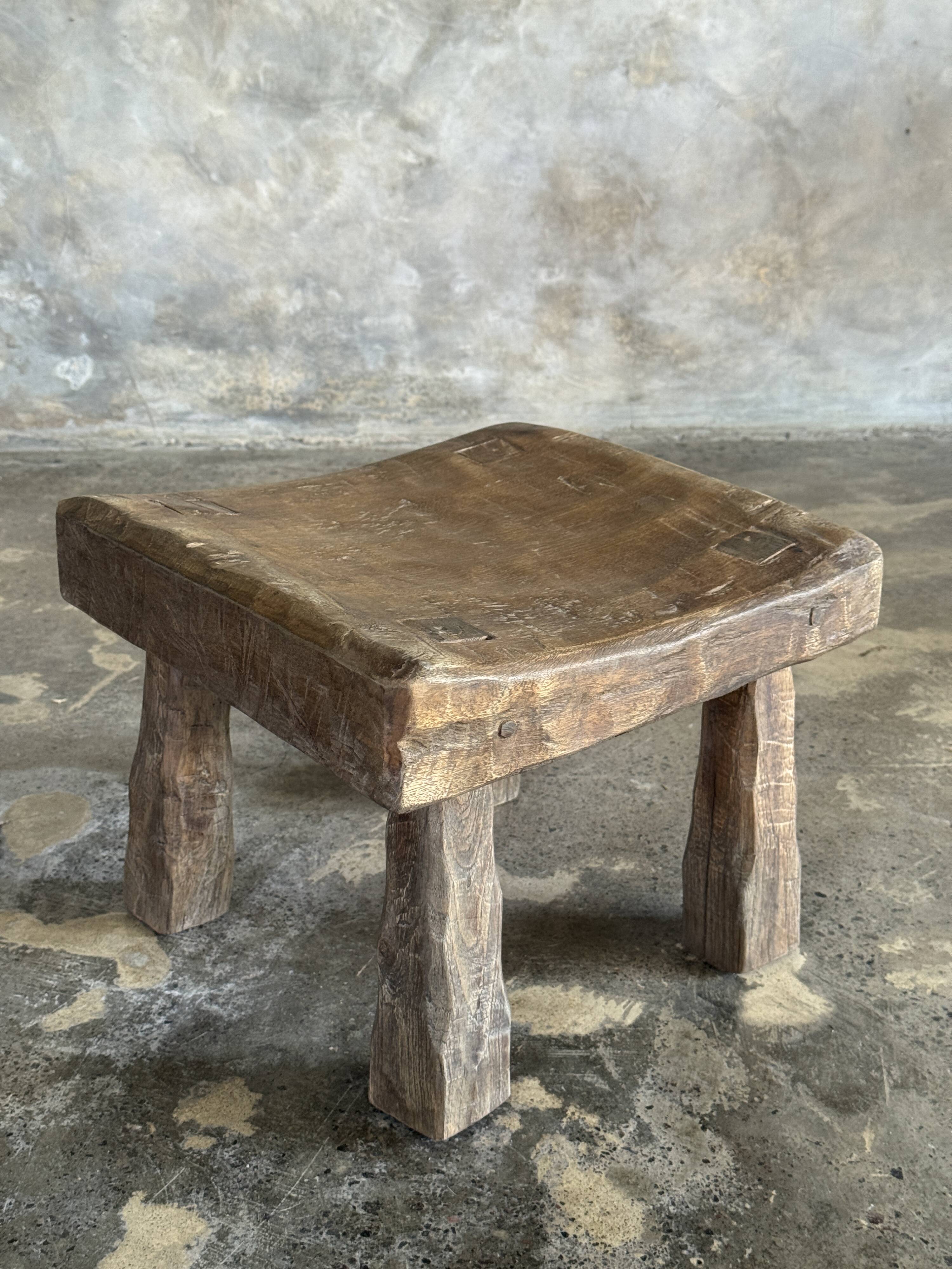 Small stool, square solid teak side table with a curved seat.
