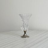 Small vase on a metal stand with thick glass.