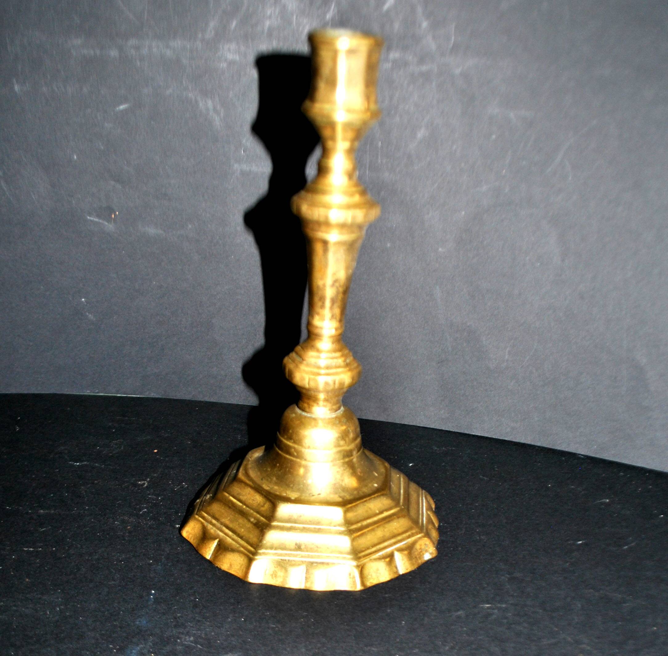 Antique 18th-century octagonal cut-out bronze candlestick in the Louis XIV style.