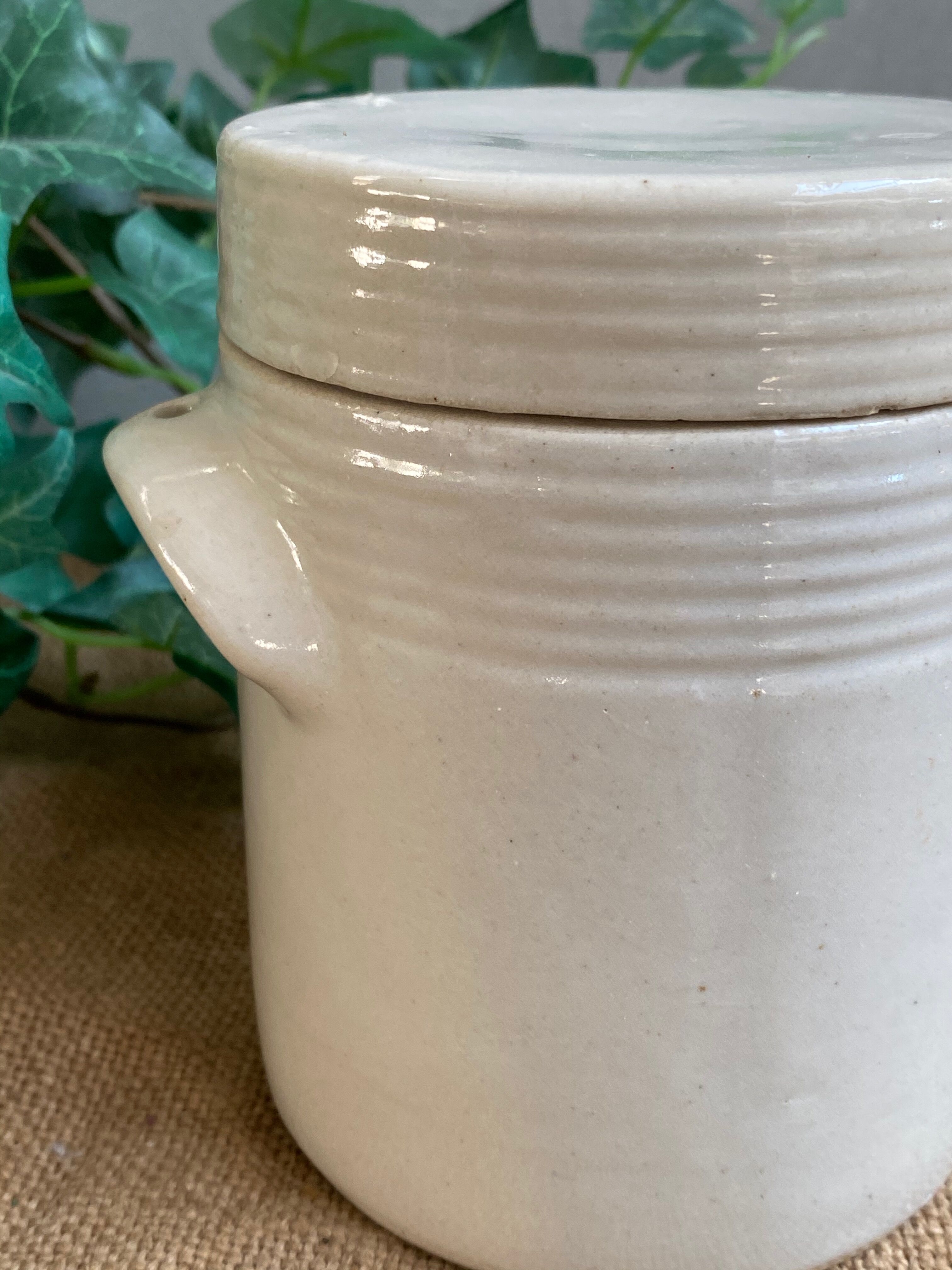 White pot in glazed earth