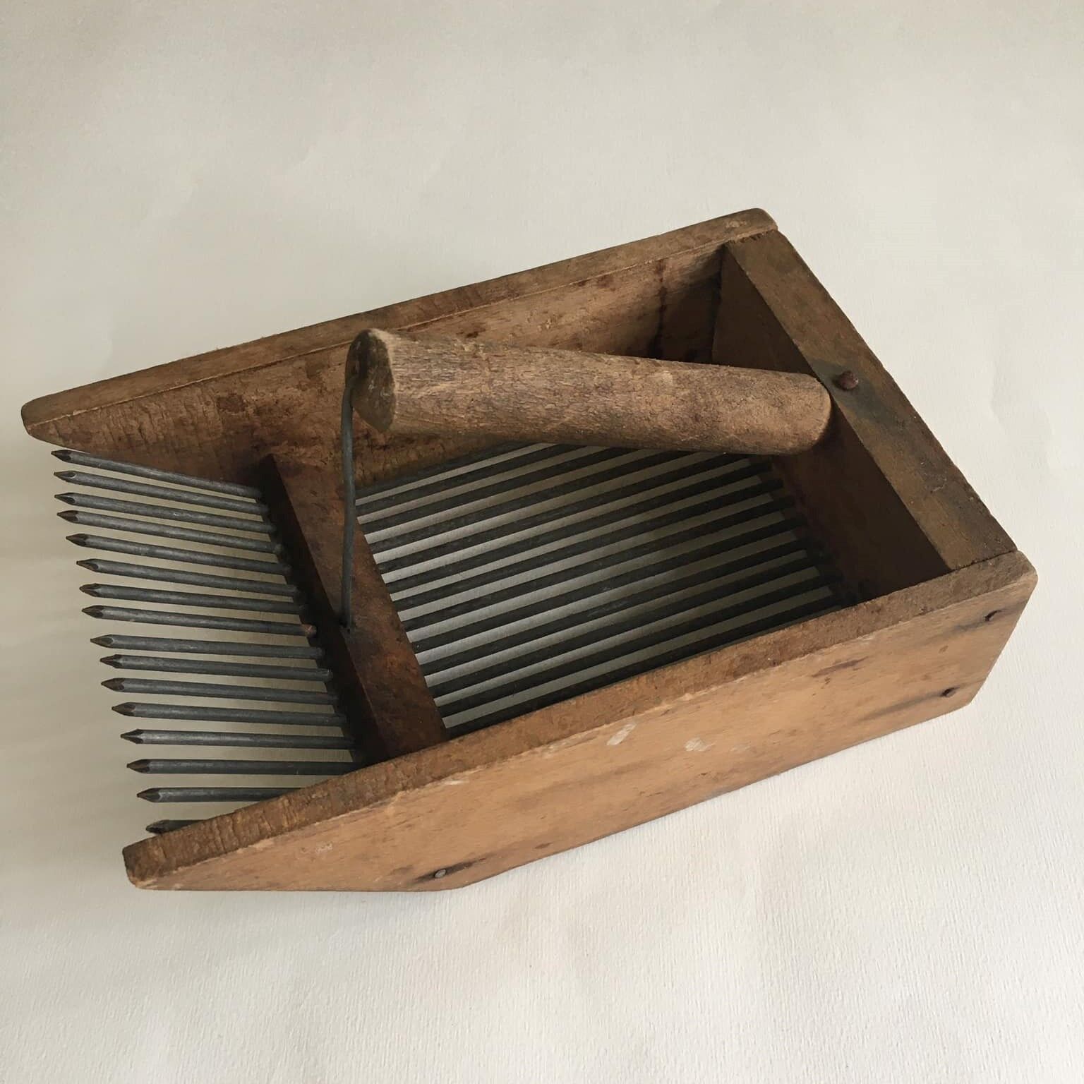 Old comb with berries (blueberries ..) in wood and metal