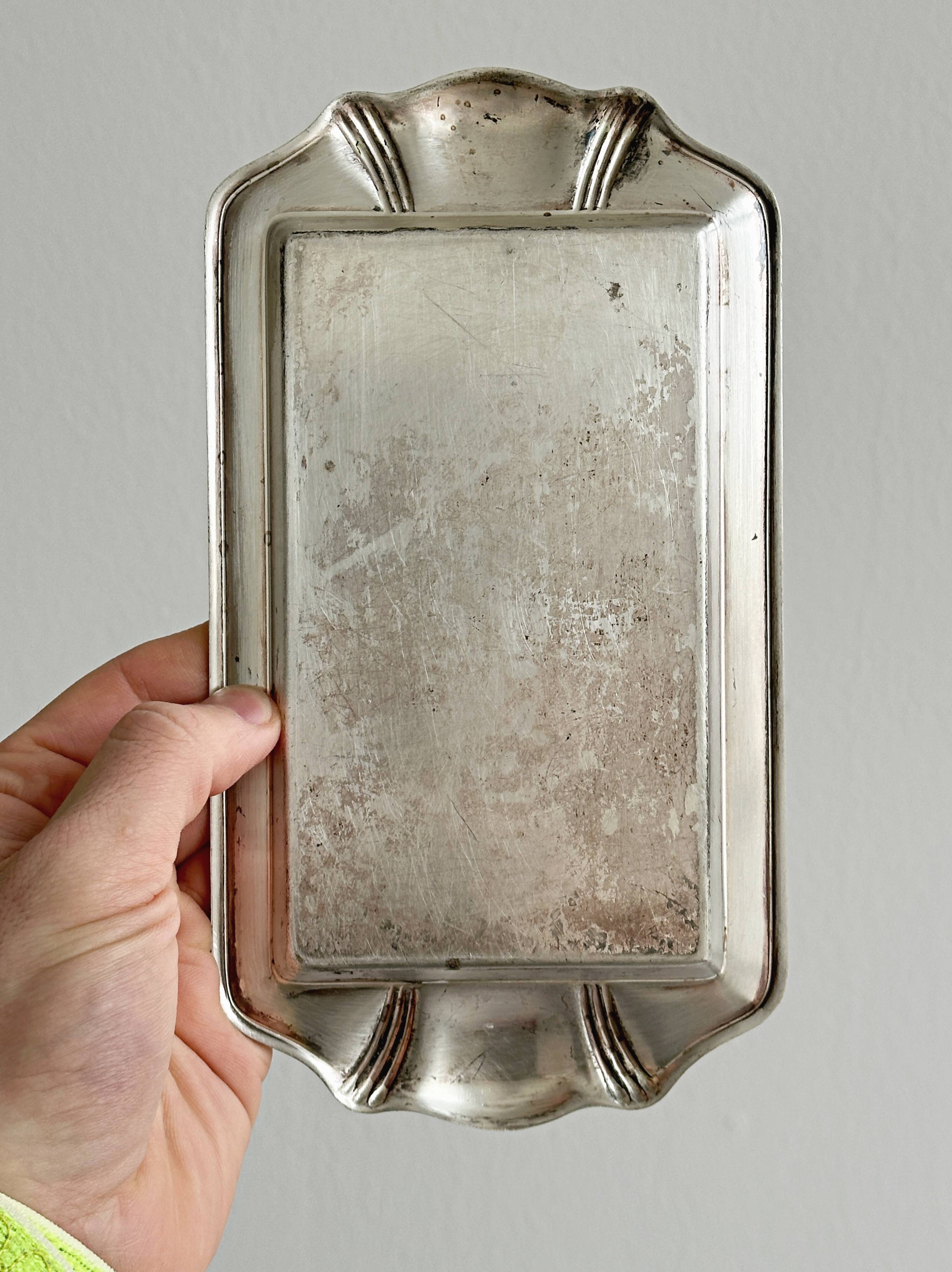Metal butter dish and thick rectangular glass bowl.