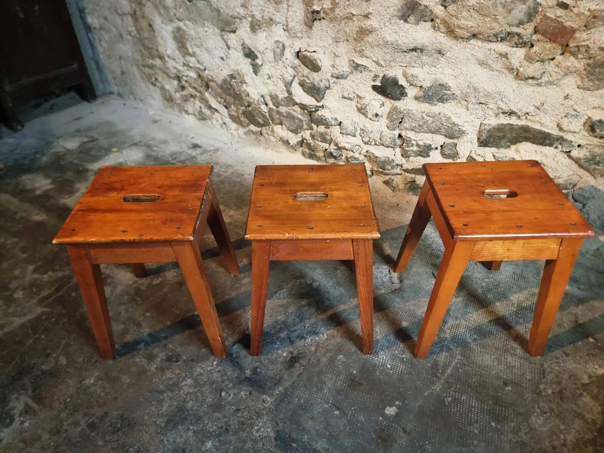 Set of 3 vintage French wooden stools from the 1950s.