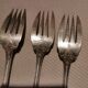 3 silver metal forks