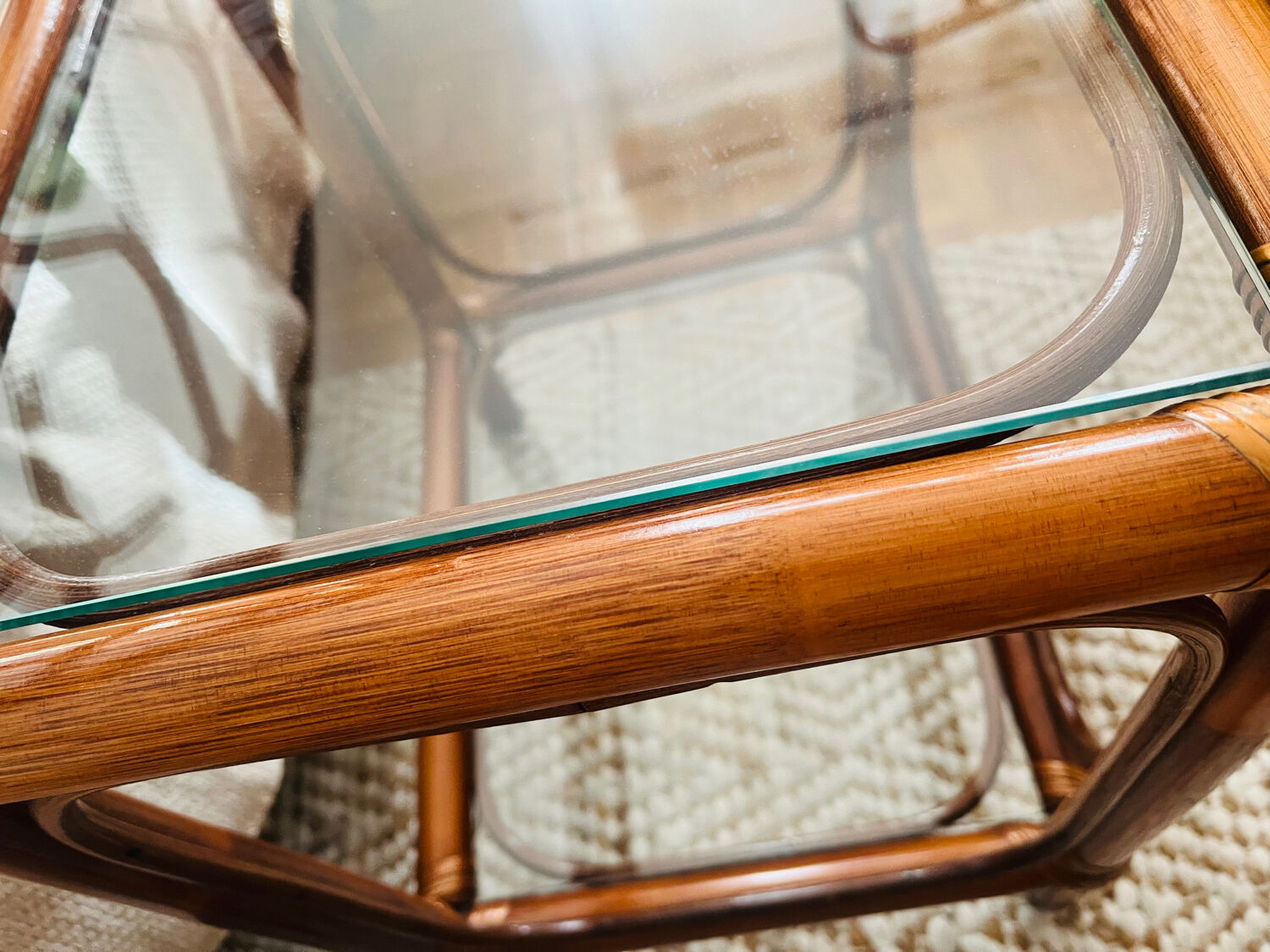 Two rattan and glass bedside tables