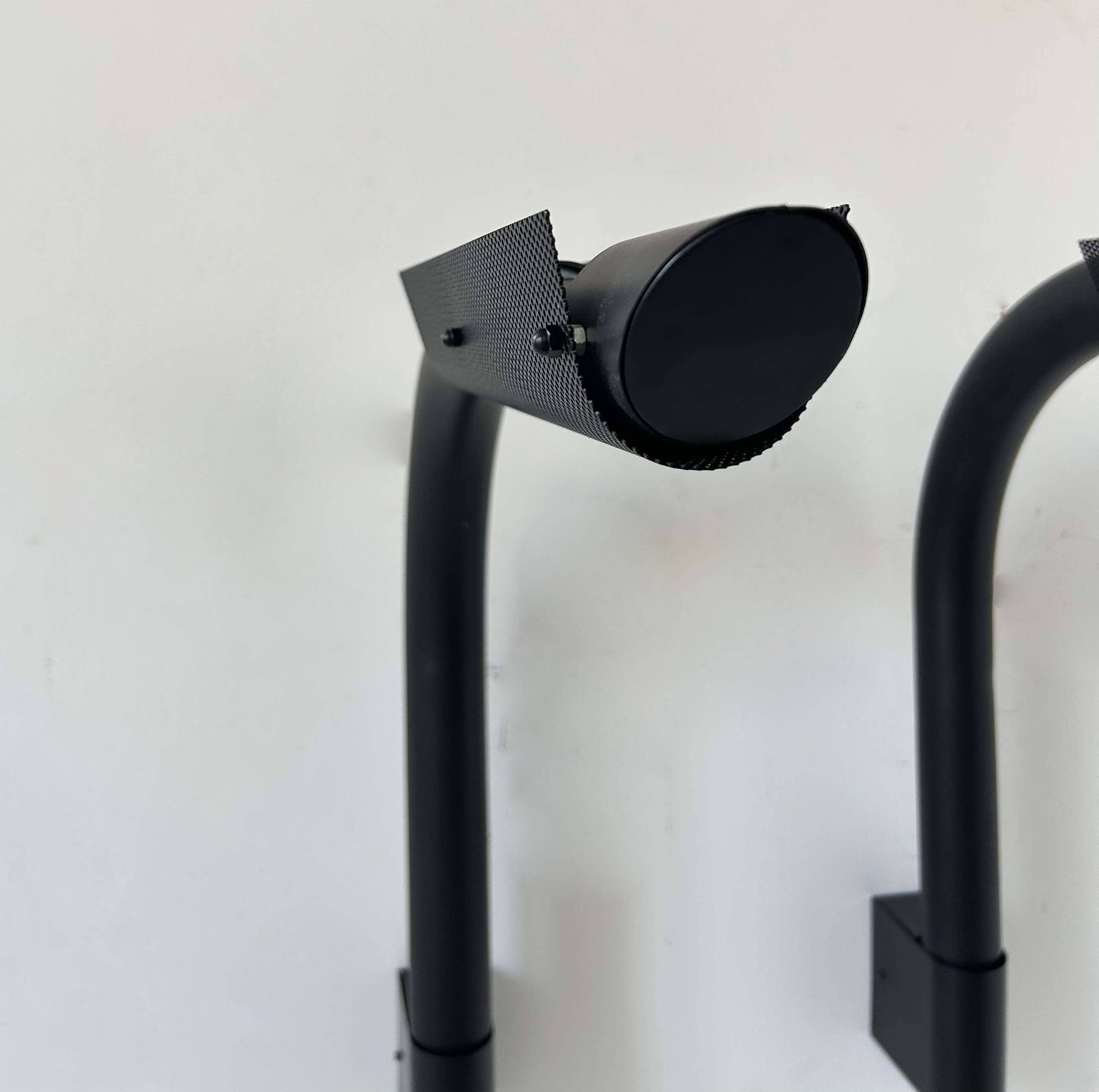 Pair of vintage wall lights, tubular and perforated black metal, Parscot France 1980