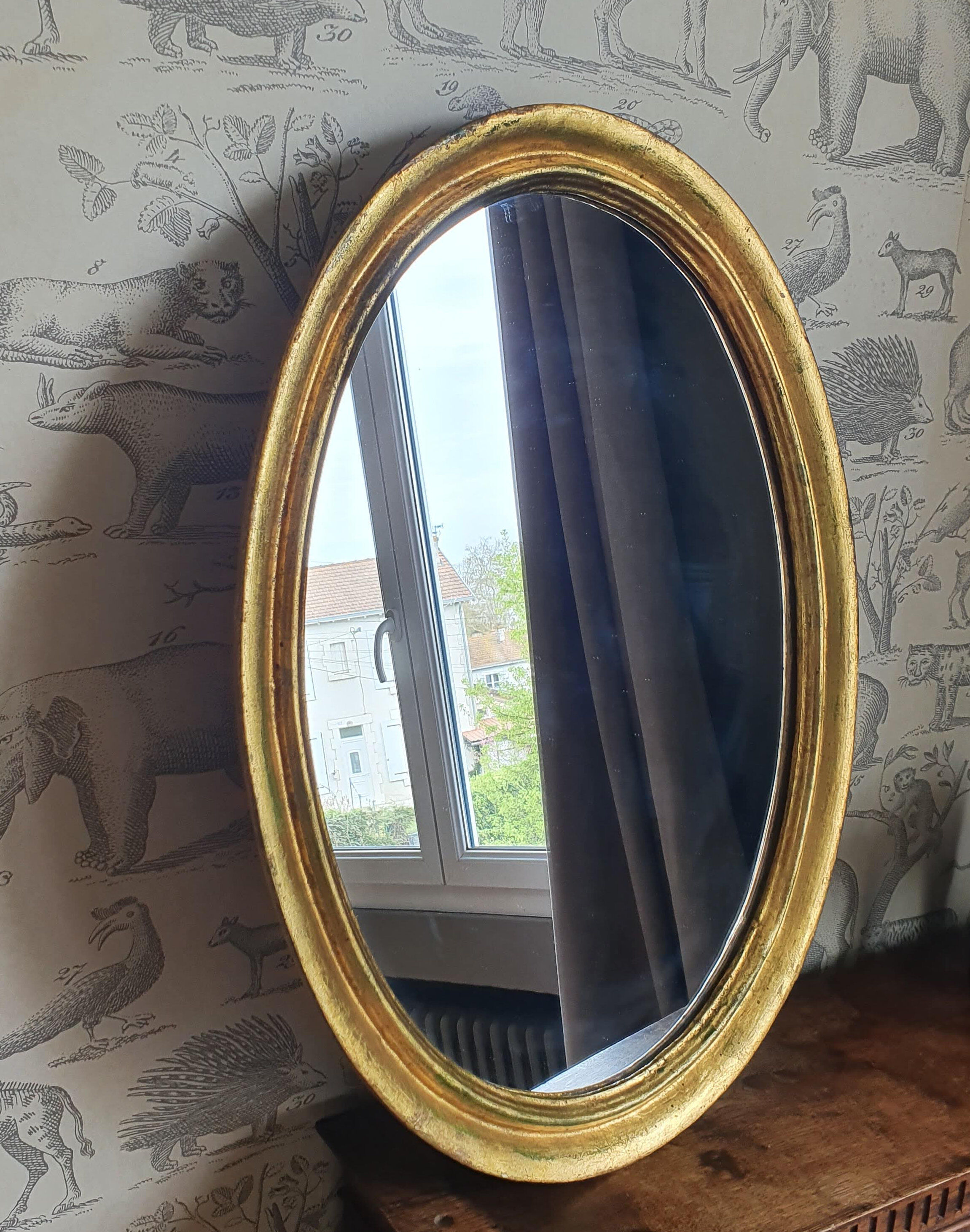 Oval mirror in gilded wood 67X52