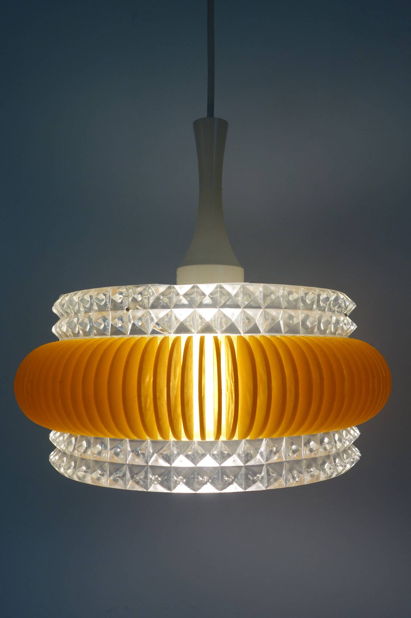 Transparent plastic space age lustre with orange band from the 70s.