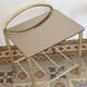 Pair of bedside tables with gold metal and mirrored glass top.