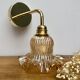 Gold bent wall light vintage tulip in amber glass.