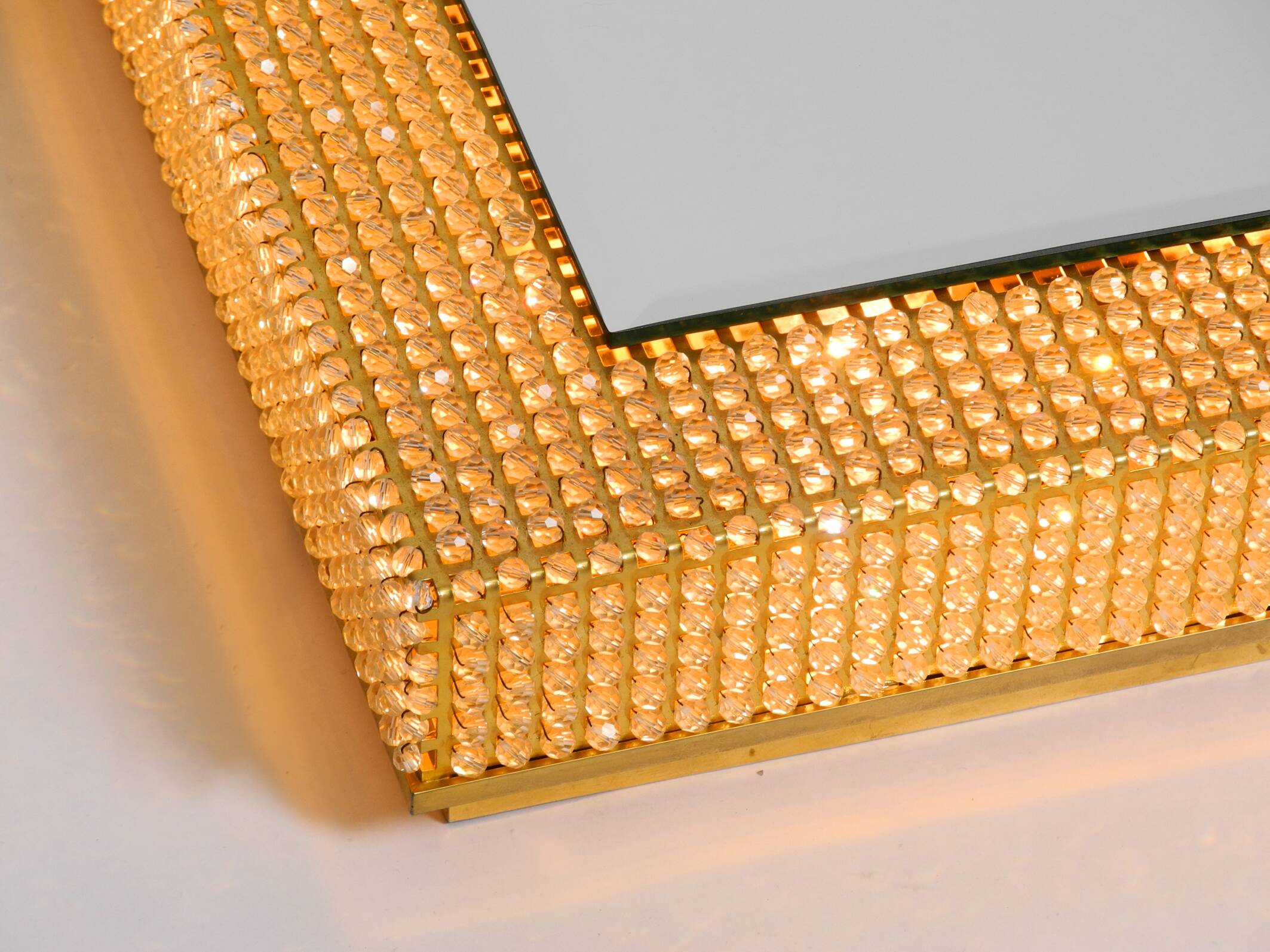 1960s brass wall backlit mirror, frame with glass beads by Palwa