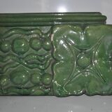 Green enamelled ceramic stove tile — finely sculpted Hungarian pattern from the late 19th century.