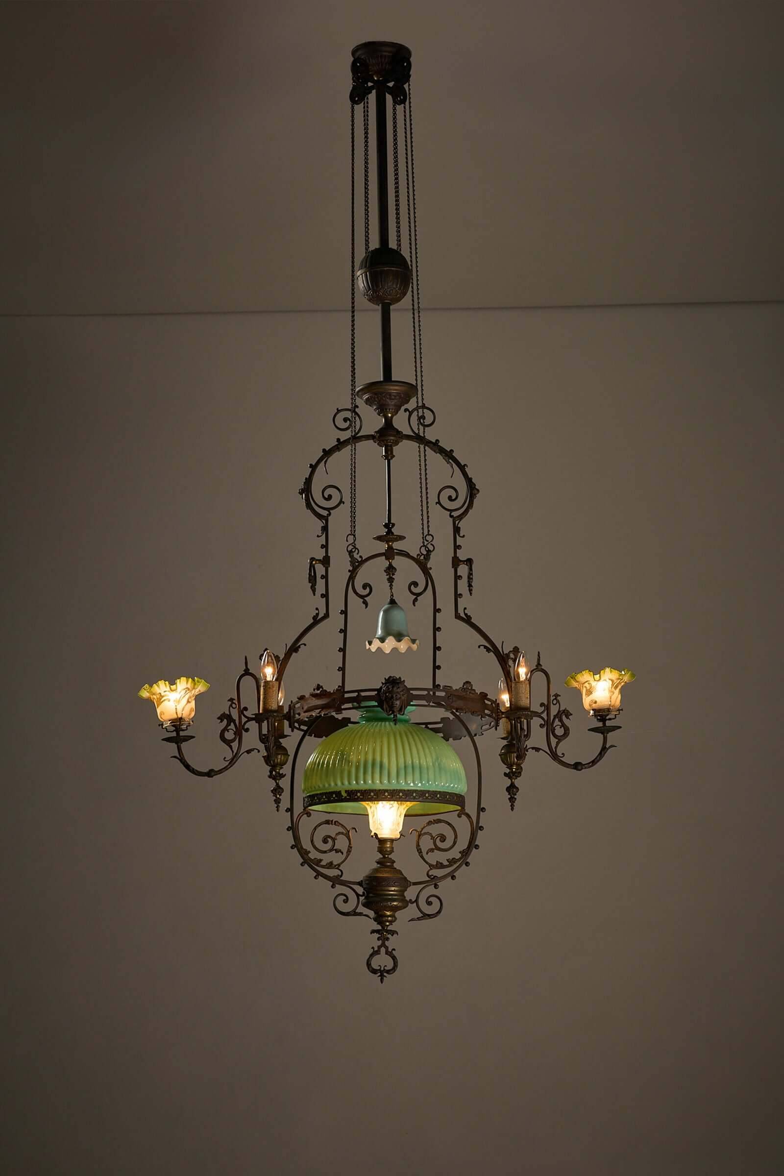 Antique adjustable height chandelier with original glasswork and brass detailing