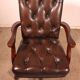 Office chair known as a director's chair in wood and tufted leather.