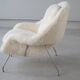 Womb Chair and Ottoman in fluffy white fabric by Eero Saarinen