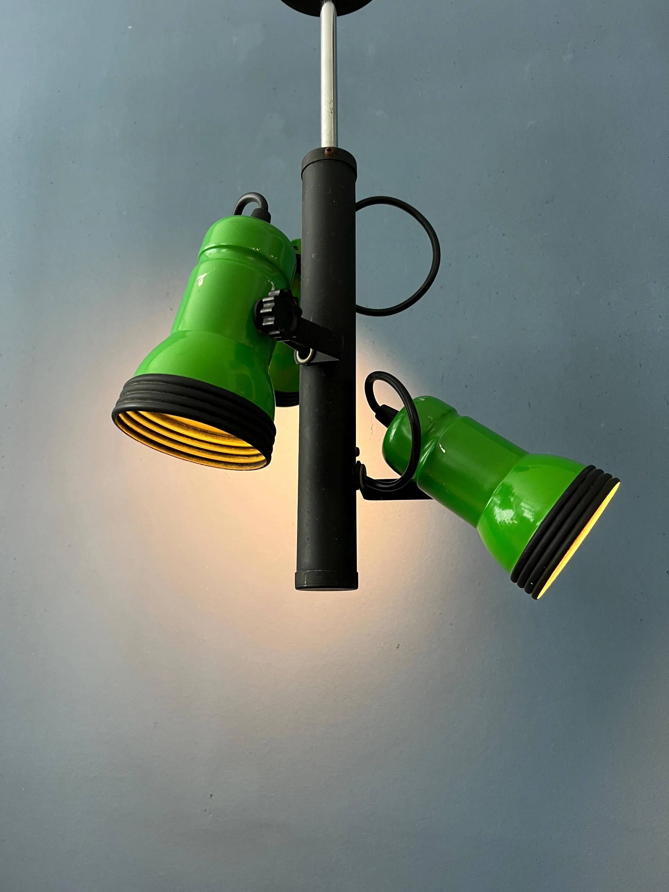 Vintage pendant light with three green spots.