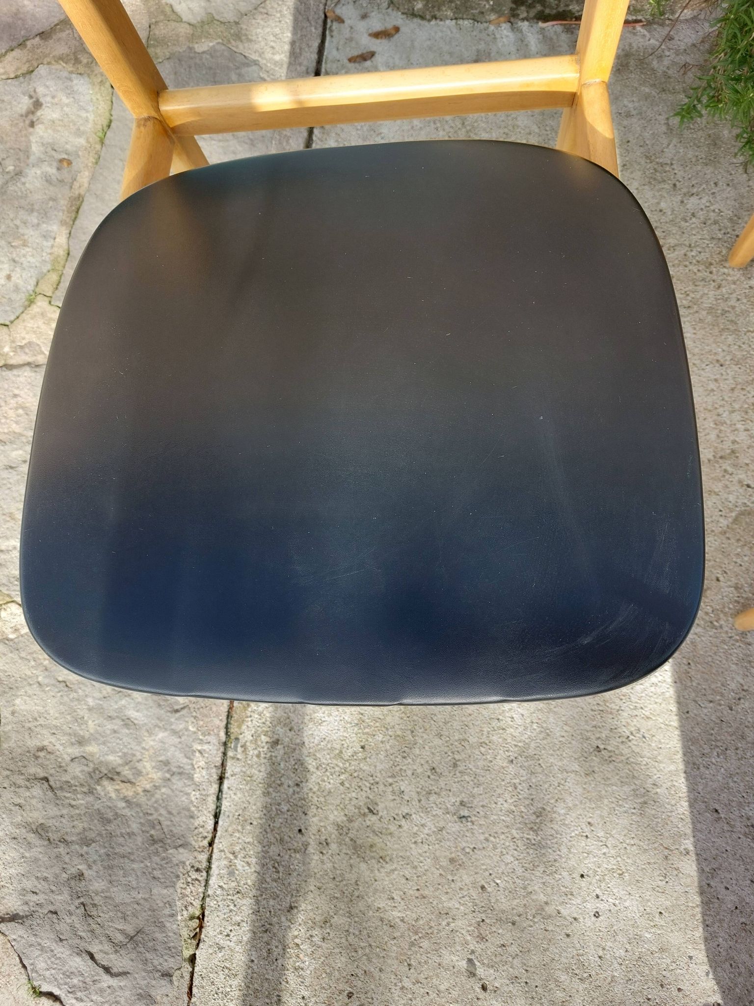 3 Scandinavian style chairs, light wood and black faux leather.