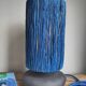 Table lamp in black stoneware and natural raffia.