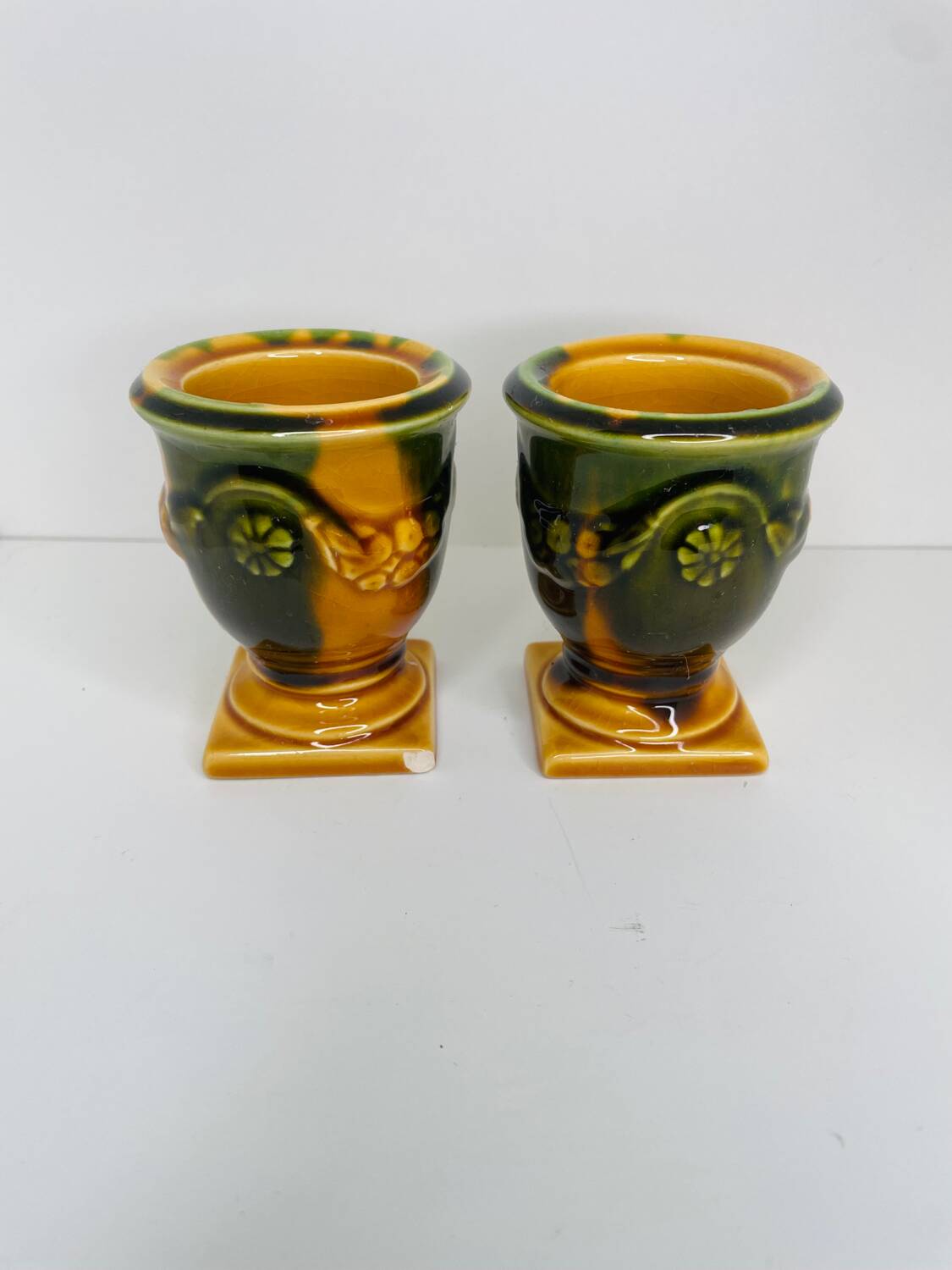 Pair of ocher and green ceramic point-a-line candlesticks