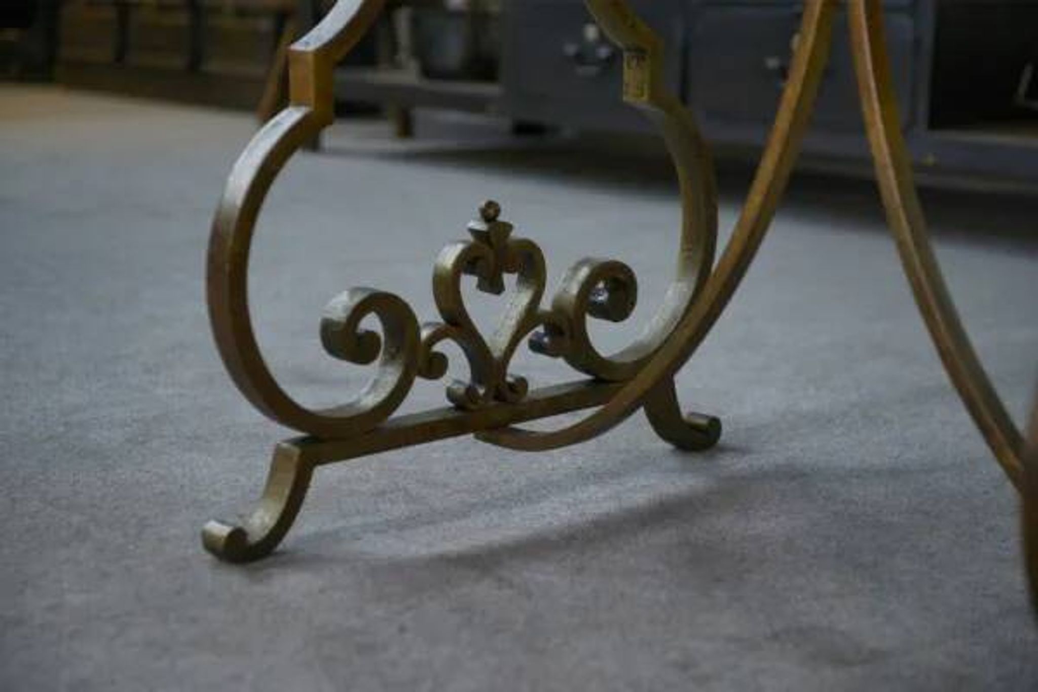 Side table with a gilt wrought iron base attributed to Gilbert Poillerat, with a travertine top, 1940s