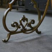 Side table with a gilt wrought iron base attributed to Gilbert Poillerat, with a travertine top, 1940s