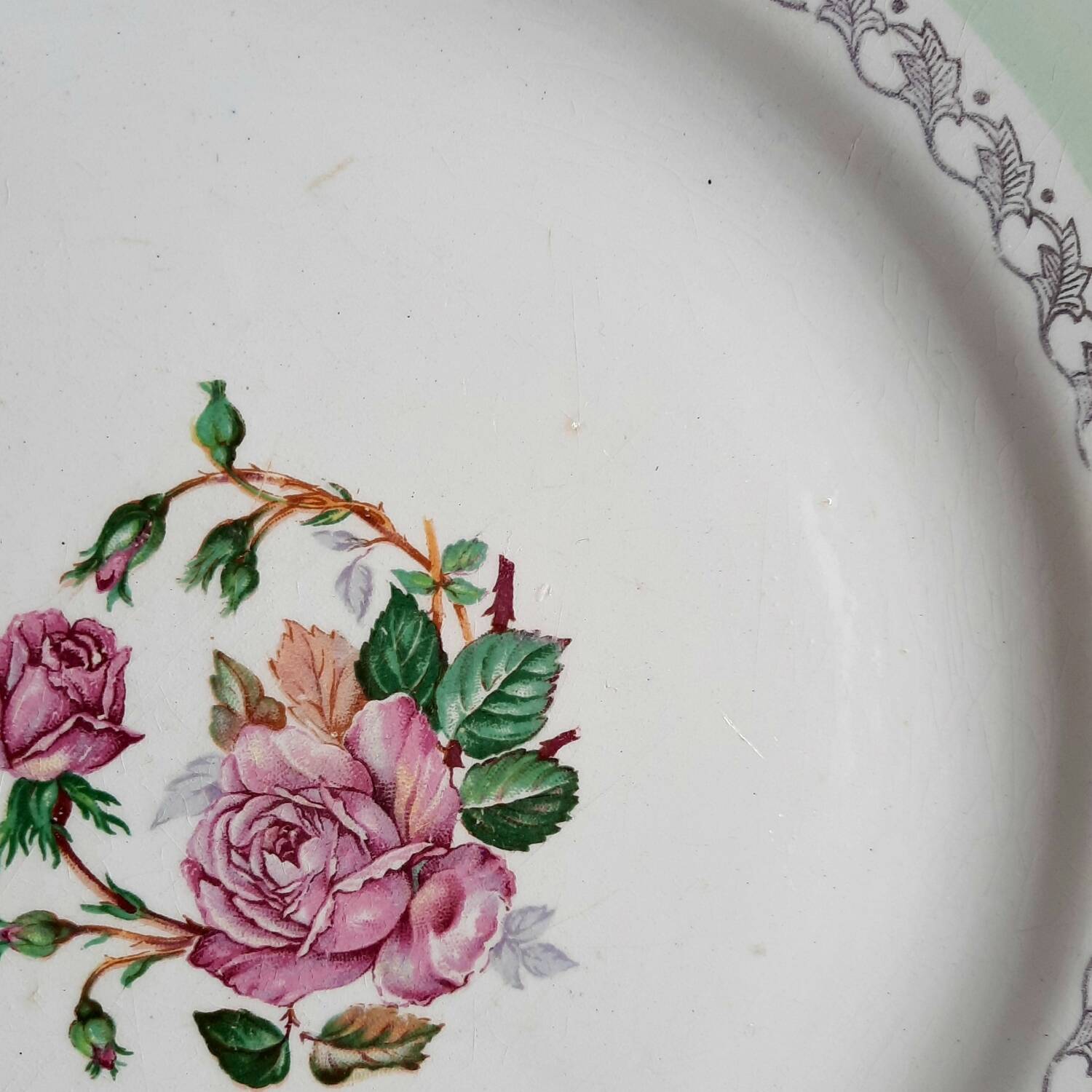 Old mismatched earthenware dinner plates accompanied by a deep dish