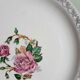 Old mismatched earthenware dinner plates accompanied by a deep dish