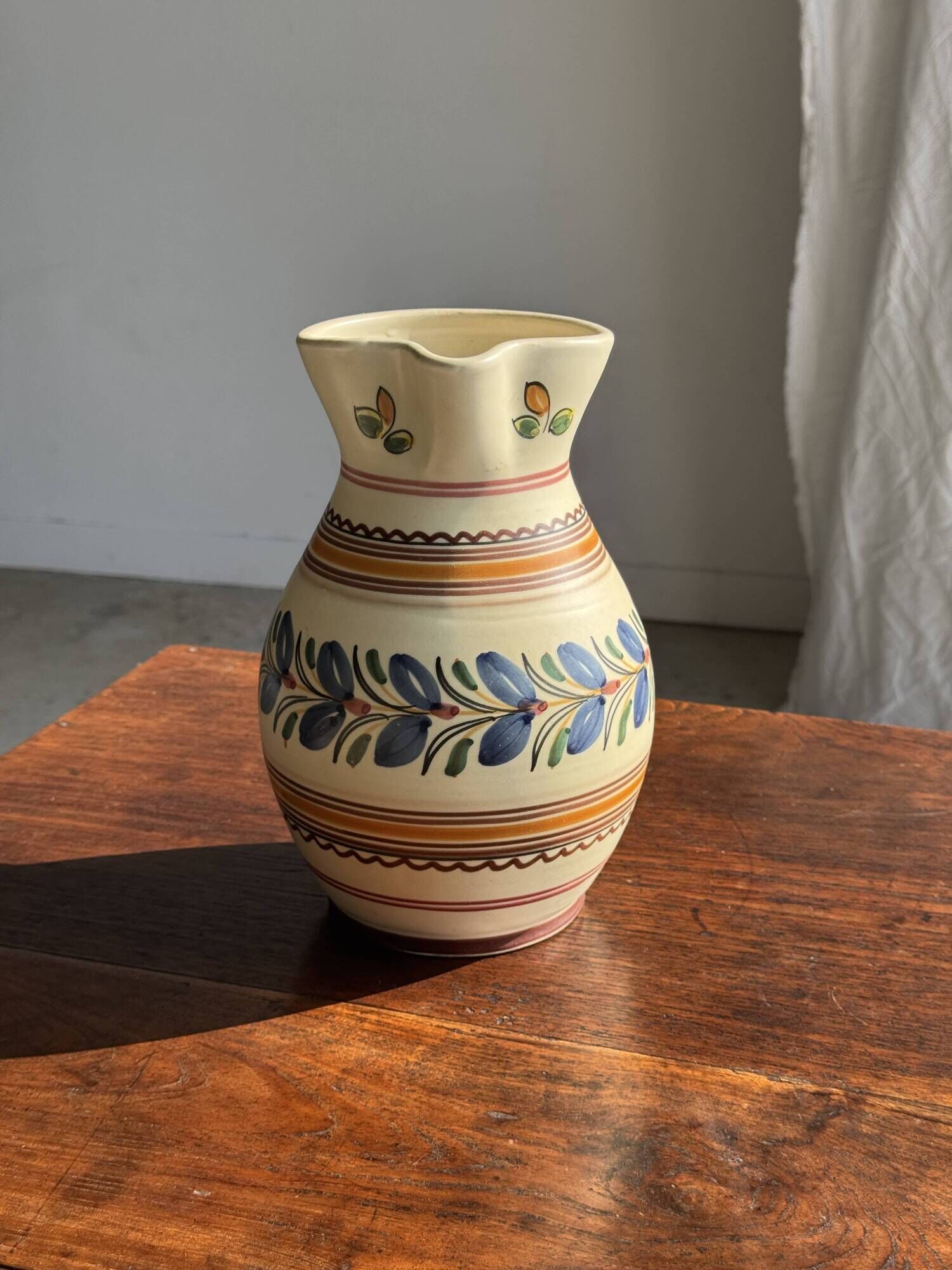 Beige carafe with stylized blue flower friezes