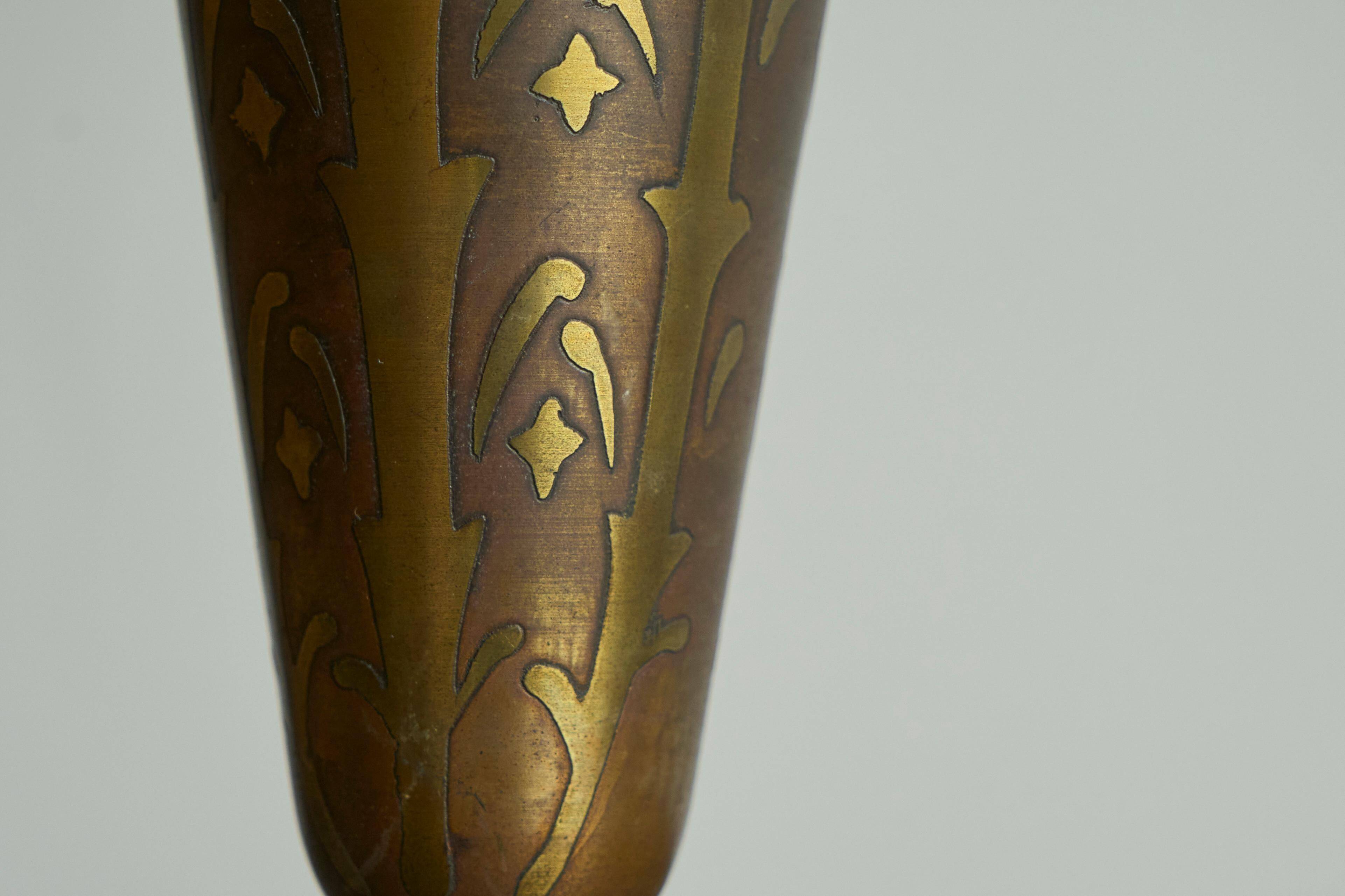 Art Deco fluted vase in patinated metal and brass from the 1930s.