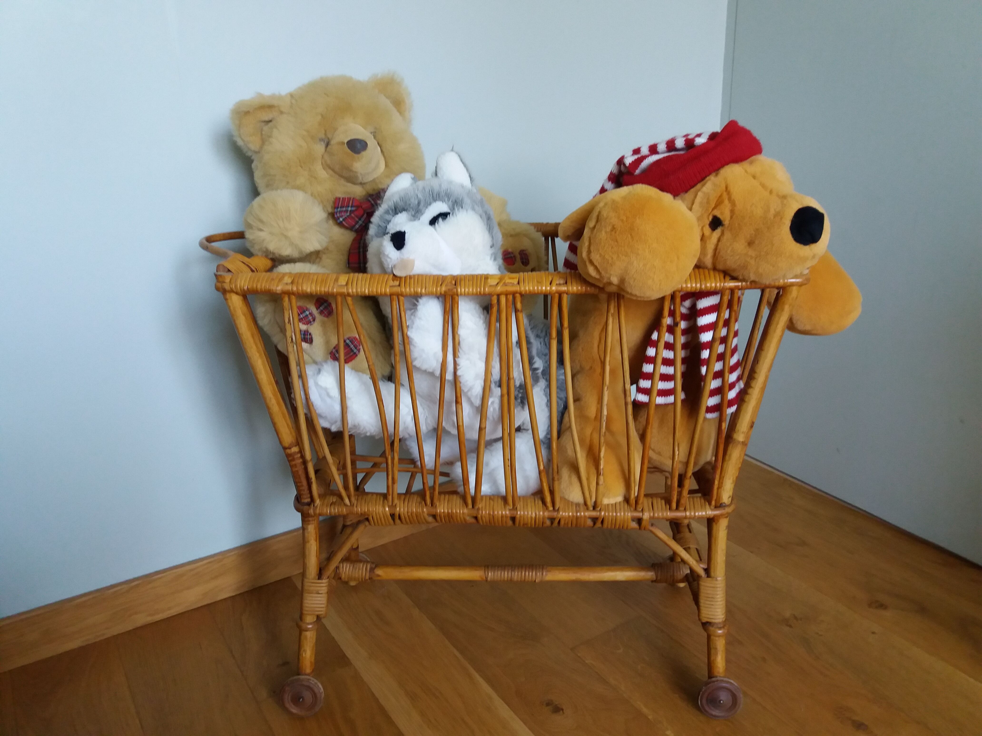 Rattan wicker cradle on wooden wheels