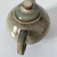Vintage ceramic teapot with a flame design.