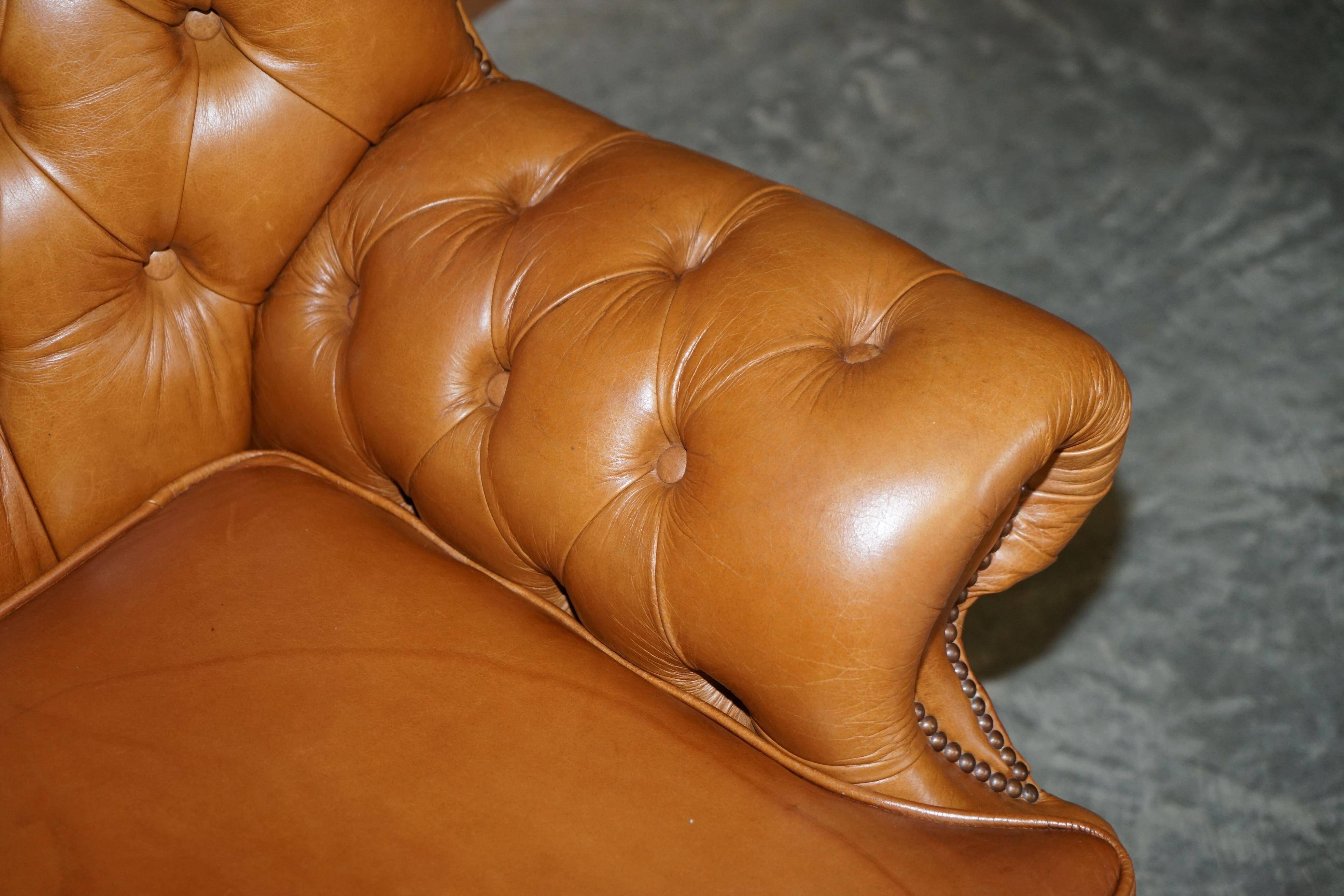 Small Chesterfield leather sofa with a high back.