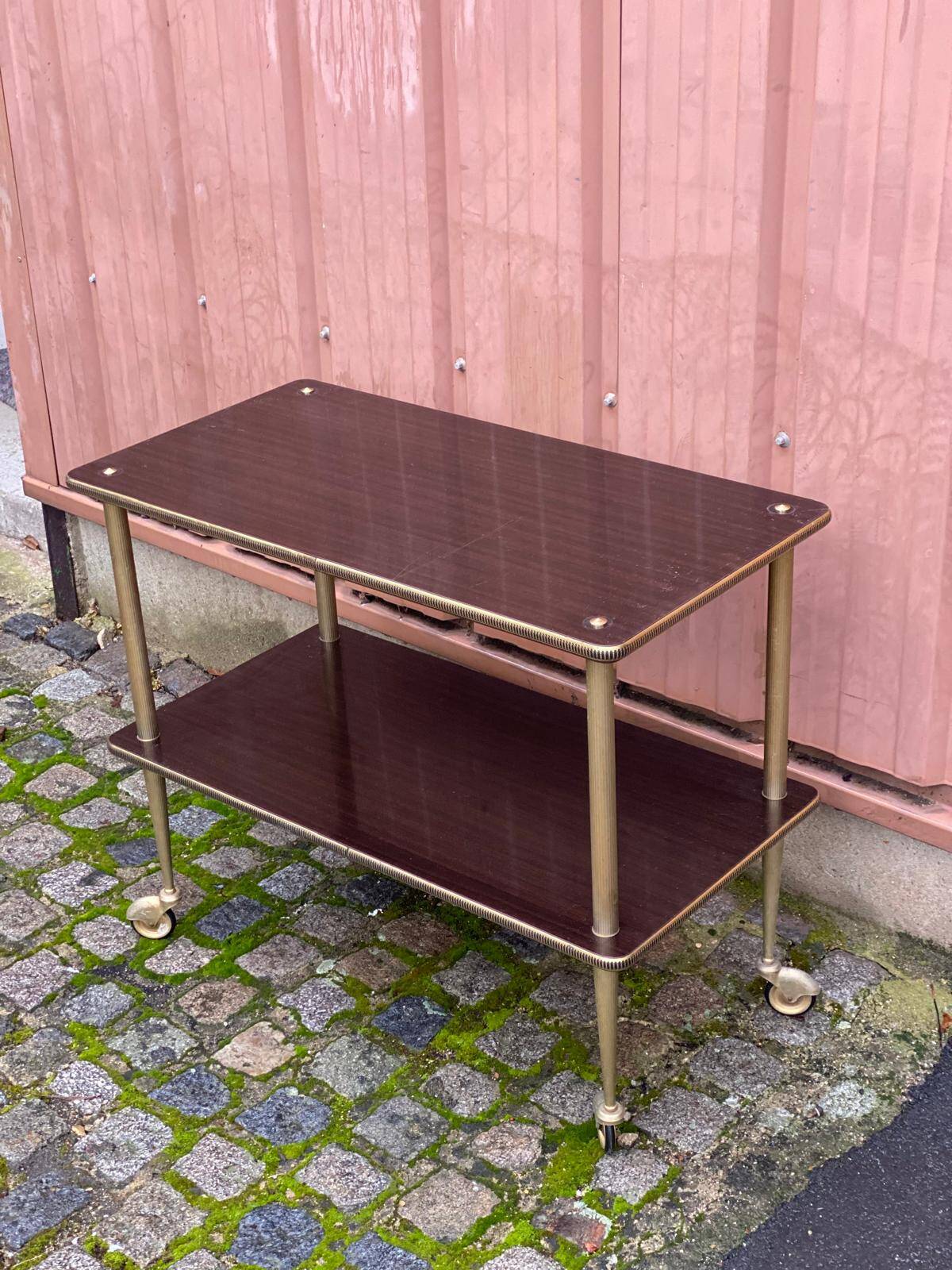 Brown rosewood rolling table with gold fluted legs